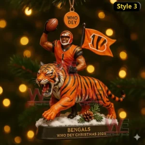 A Bengals Christmas ornament displaying a number 1 player raising a football beside a tiger with a Who Dey tag and team flag.