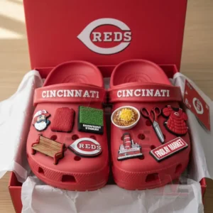 Cincinnati Reds Crocs decorated with various team-themed charms inside a red box.