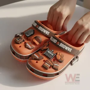 Cleveland Browns Crocs Crocband Clogs With Charms 7 Hands holding orange Cleveland Browns clogs decorated with football charms on a bright surface!