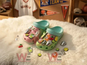 Pink and green clogs covered with cocktail ingredient charms displayed on a soft rug with sports decor in the background!