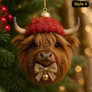 A highland cow Christmas ornament wearing a red knit hat and gold bow on a tree!