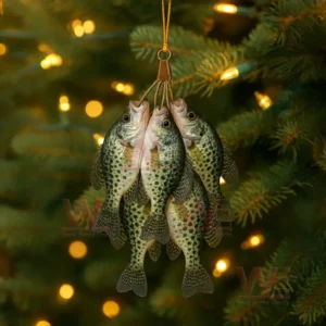 Grouped fish ornaments hanging by a cord in front of a lit tree background!
