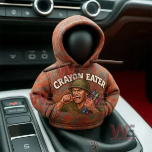 A hooded figurine on a car gear shift wearing a multicolored hoodie with a soldier graphic holding crayons!