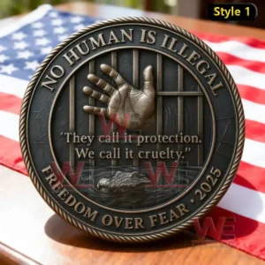 A detailed coin design displays a hand reaching through metal bars representing oppression and the call for human dignity placed on a table with an American flag background.