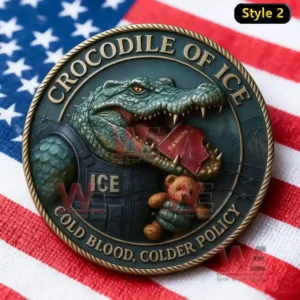 A detailed metallic coin illustration shows a crocodile in armor with text Crocodile of Ice representing cold hearted immigration policy against a backdrop of the American flag.