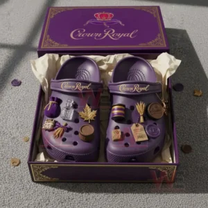 Purple Crown Royal themed clogs placed inside an open box with multiple charms attached to the front of each shoe!