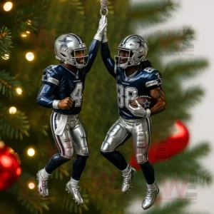A Christmas ornament of two Dallas Cowboys players celebrating on a tree decorated with lights and red ornaments in the background!