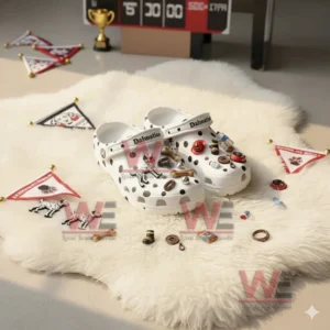 White spotted clogs decorated with Dalmatian themed charms displayed on a soft rug with small flags placed around!