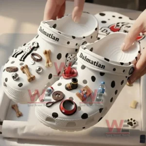 Hands holding white spotted clogs decorated with Dalmatian themed charms above a matching box!
