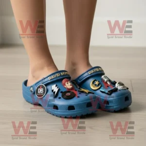 David Bowie Crocs Clogs with Charms 8 Person wearing blue David Bowie Crocs with colorful themed charms standing on a light wooden floor in a bright room!