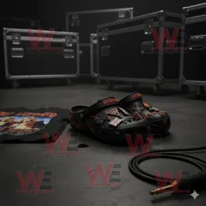 Black Def Leppard Crocs with band themed charms on a stage floor near a shirt and audio cable!