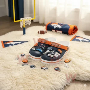 Navy Denver Broncos clogs with assorted football charms displayed on a white furry rug with team decor!