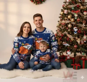 Family in Denver Broncos Snoopy Christmas sweaters sitting by a Christmas tree with gifts.