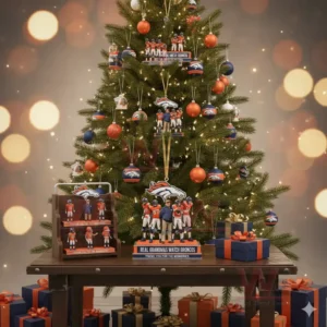 A family of four in Denver Broncos Christmas sweaters, sitting on the floor with a decorated tree in the background.