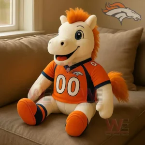Denver Broncos Thunder Plush Pillow 3 Denver Broncos plush horse mascot wearing an orange football jersey sitting on a beige sofa near a window.