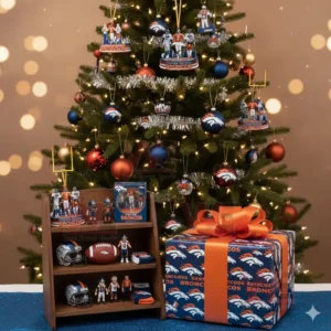 Alt text: A Christmas tree decorated with Denver Broncos ornaments, a gift box, and figurines of Broncos players.