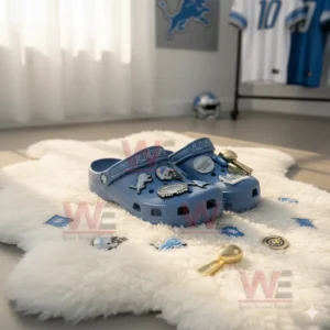 Blue Detroit Lions clogs with football charms displayed on a white furry rug in a team themed room!