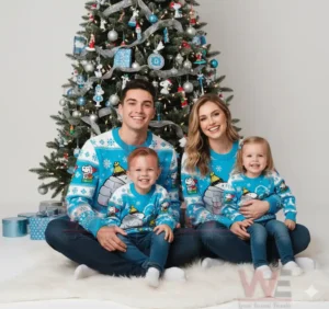 Alt text: A family of four in blue Christmas sweaters with Snoopy characters, sitting in front of a Christmas tree.