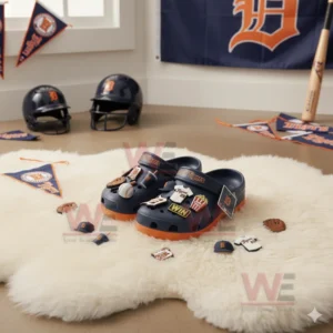 Navy Detroit Tigers clogs with baseball charms displayed on a white furry rug in a sports themed room!