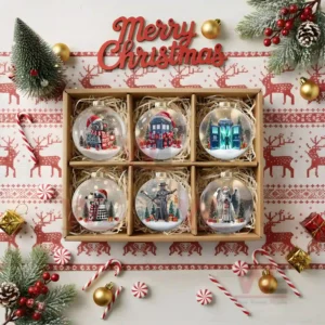 A gift box containing six clear Christmas ornaments each with a snowy scene including characters trees and gifts!