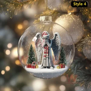 A clear Christmas ornament showing an angel statue in a snowy scene with trees and gifts!