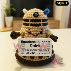 A cute crochet robot doll with a cheerful face holding a positive message sign on a table!