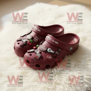 Maroon Dr Pepper Crocs with bottle and cherry charms on a fluffy white background!