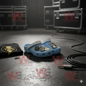 Elvis Presley Crocs Clogs with Charms 6 Light blue Elvis Presley Crocs with gold charms beside TCB shirt and microphone cable on stage floor!