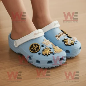 Elvis Presley Crocs Clogs with Charms 8 Person wearing light blue Elvis Presley Crocs with gold musical charms on wooden floor!