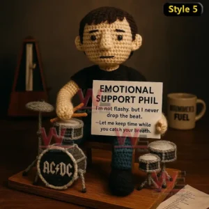 Emotional Support AC/DC Rock Band Doll 8 Crochet doll with long hair holding guitar and AC DC support sign on a table.