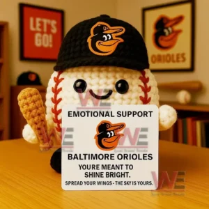 Crochet baseball doll wearing Phillies cap holding bat and Emotional Support Philadelphia Phillies sign with sports decor background.