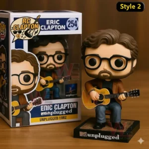 Eric Clapton Unplugged collectible figure sitting with a guitar shown beside its product box placed on a wooden table.