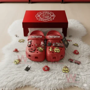 Firefighter-themed Crocs with firefighting charms on a soft surface.