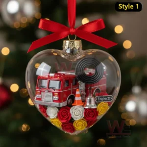 Alt text: A close-up of a heart-shaped ornament containing a miniature fire truck, cones, and fire-fighting equipment.