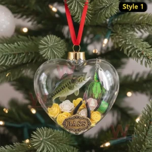 Alt text: A close-up of a heart-shaped ornament containing a miniature bass fish, fishing lure, and tools like pliers, surrounded by roses.