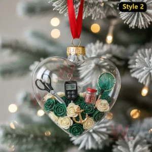 Alt text: A heart-shaped ornament filled with fishing tools like a net, thermometer, and anchor, surrounded by green and white roses.