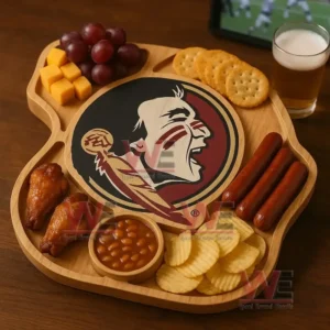 A wooden tray with a central team emblem filled with snacks sits on a wooden table next to a glass of beer with a sports screen in the background!