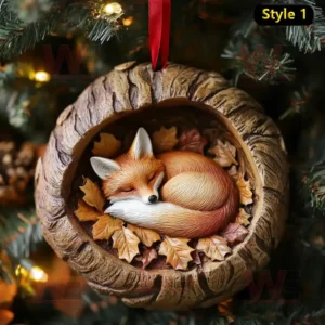 Sleeping fox ornament in hollow tree trunk with leaves hanging on Christmas tree!