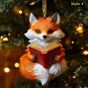 Fox holding red book ornament hanging on Christmas tree with glowing lights!