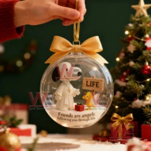 A transparent Christmas ornament ball with Snoopy dressed as an angel and a small bird companion symbolizing friendship placed against a festive background.
