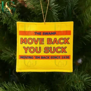 Yellow Christmas ornament with blue and orange text hanging on a green Christmas tree branch!