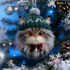 A long haired cat ornament with a green knit hat and bow hanging on a Christmas tree!