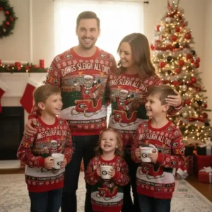 Alt text: A family in matching Georgia Bulldogs Christmas sweaters with the slogan "Dawgs Sleigh All Day" and a festive Christmas background.