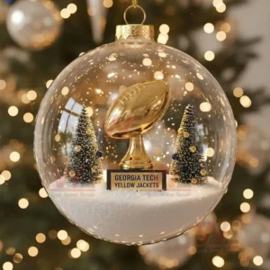 A Christmas ornament with a golden football trophy, snowy trees, and the Georgia Tech Yellow Jackets logo on the base.