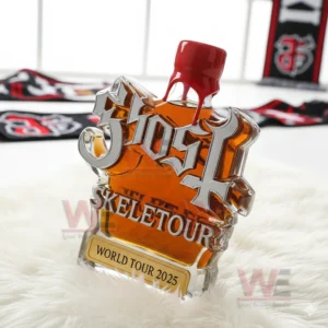 A sculpted Ghost bottle positioned on a white rug with themed decorations around it.