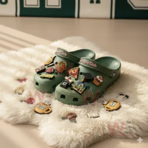 Gilmore Girls Crocs Clogs with Charms 6 Green Gilmore Girls Crocs shown on a fluffy surface with loose charms including mugs, sweaters, and cupcakes arranged around them!