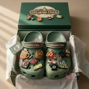 Gilmore Girls Crocs Clogs with Charms 7 Light green Crocs with Gilmore Girls branding and themed charms such as diner mugs and desserts neatly displayed in their box under sunlight!