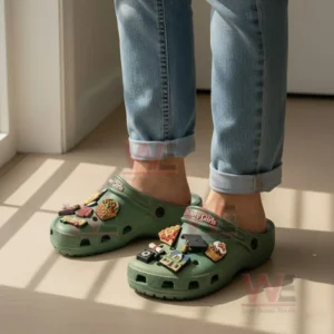 Gilmore Girls Crocs Clogs with Charms 8 Green Crocs with Gilmore Girls themed charms like pie, graduation cap, and coffee cup shown on feet in a bright indoor setting!