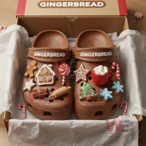 Brown clogs inside a box decorated with gingerbread house candy cane star cookies marshmallow mug and snowflake charms!