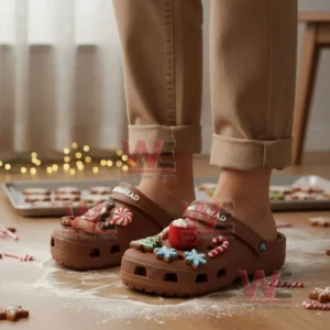 Person standing in a kitchen wearing brown gingerbread themed clogs with cookie and candy cane charms!